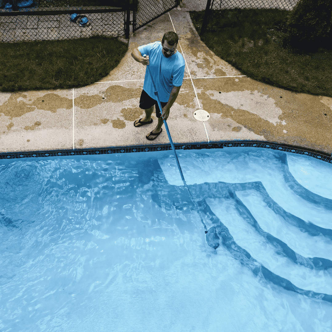 Man cleaning pool with pool brush aerial drone photo